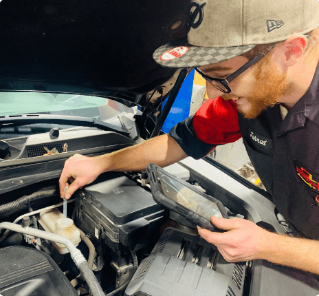 A GLP Automotive technician working performing auto repair services